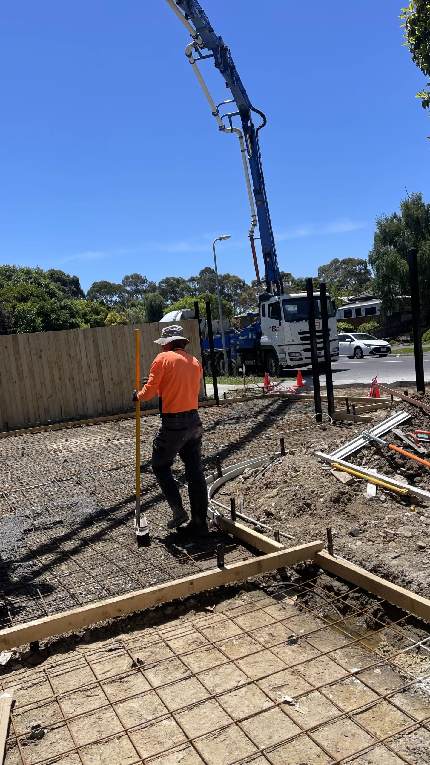 Experienced concreters in Mornington resurfacing a cracked driveway with a modern finish